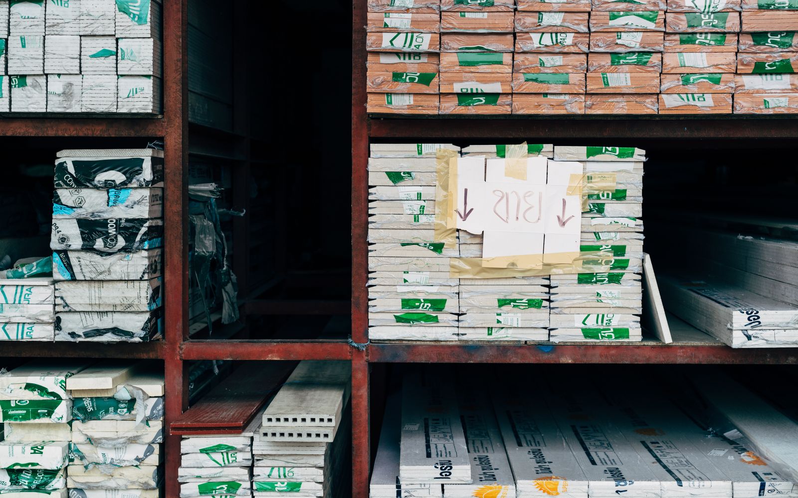 Stored product packs arranged by type on stockroom shelves